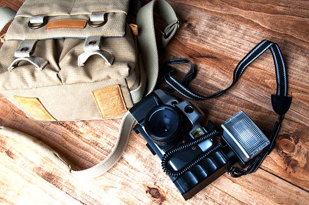 istock Old camera and bag, wooden background 540127904