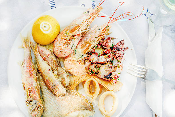 istock Cooked seafood on plate with lemon and wine 540128610