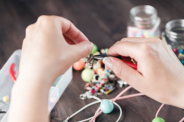 istock Woman hands making beads, closeup view 540195148