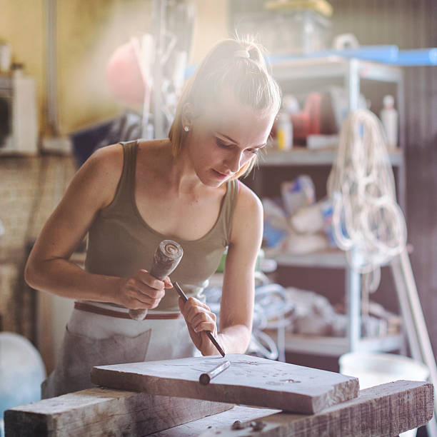 istock Young woman stonemason in her workshop 540195690