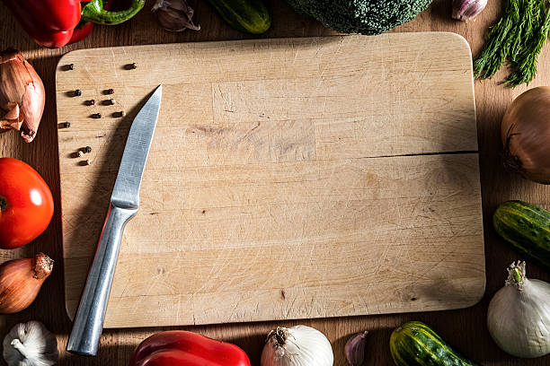 istock Autumn vegetables, spices on old wooden cutting board, table, knife 540195808