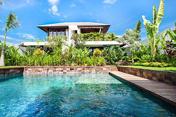 istock Modern blue water pool closeup with a garden and house 540197038