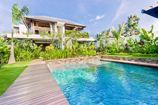 istock modern blue water swimming pool with a colorful garden 540199062