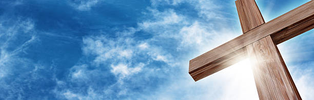Glorious Wooden Cross Wooden Cross with a Bright Blue Sky and Sun cross shape stock pictures, royalty-free photos & images