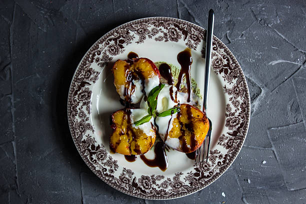 Grilled nectarines with ice cream and balsamic cream. Grilled nectarines with ice cream and balsamic cream. Top view balsamic vinegar stock pictures, royalty-free photos & images
