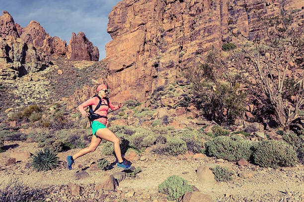 istock Woman trail running in mountains with backpack 540201976
