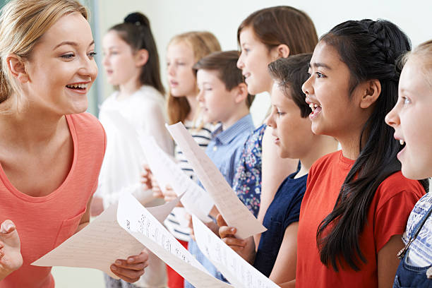istock Group Of Children With Teacher Enjoying Singing Group 540202690