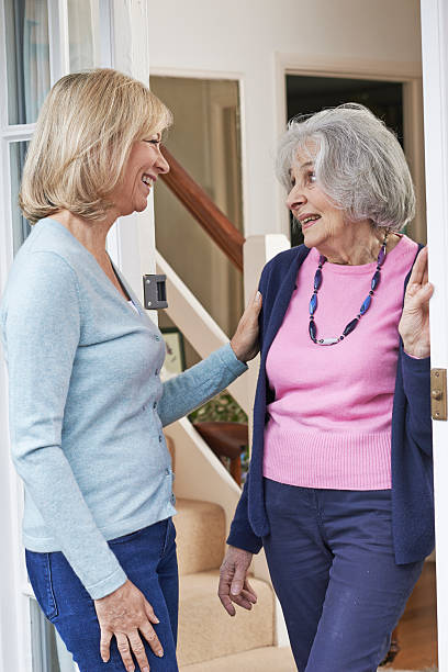 istock Woman Checking On Elderly Female Neighbor 540203828