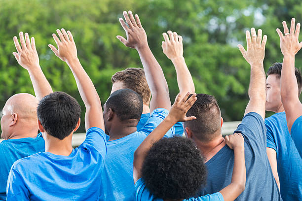 istock Rear view multi-ethnic group of volunteers raising hands 540205696