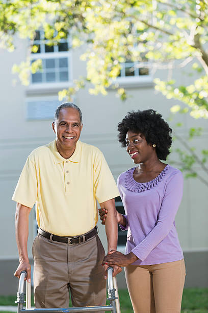 istock African American woman helping her father with walker 540206856