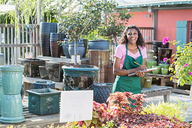 istock Black woman working in garden center taking inventory 540207128