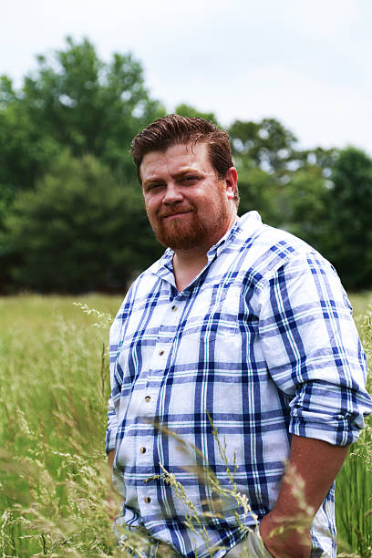 istock Man Poses For Camera in Field of Tall Grass 540207440