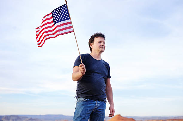 istock Man holding american flag and looking on distance 540208074