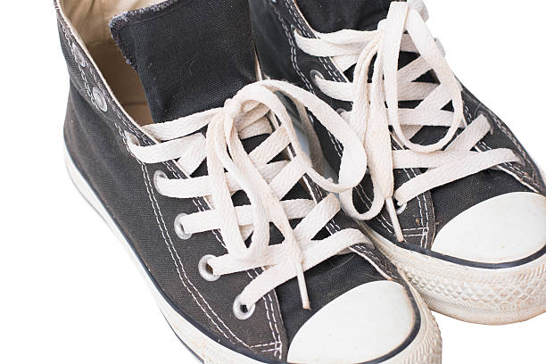 istock Pair of old black sneakers isolated on white background 540208836