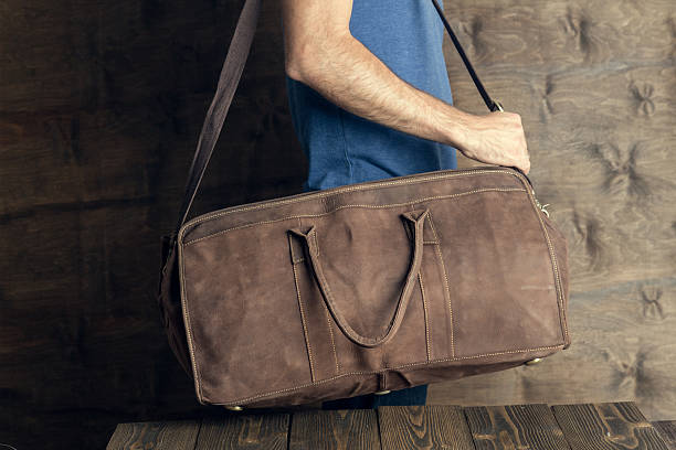 istock Young man with a brown vintage travel bag 540208952