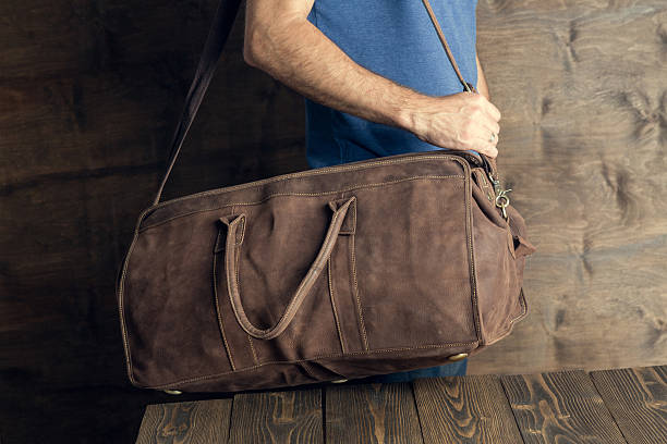 istock Young man with a brown vintage travel bag 540209040