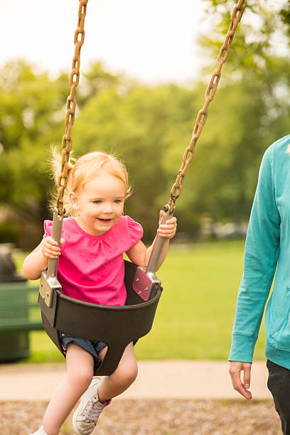 istock Happy little girl on swingset 540209082