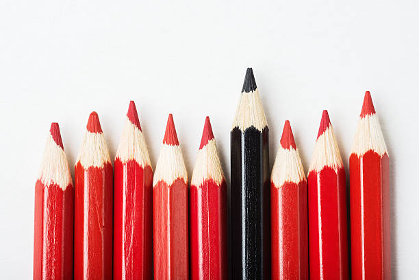 istock Pencils with one black among of red 540210398