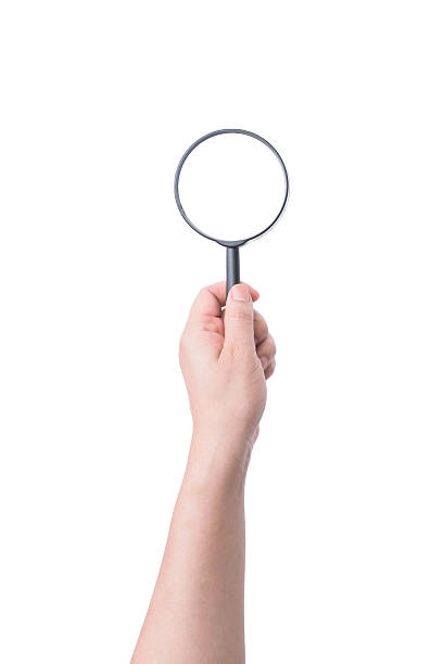 istock Female hand with magnifying glass isolated on white 540210538