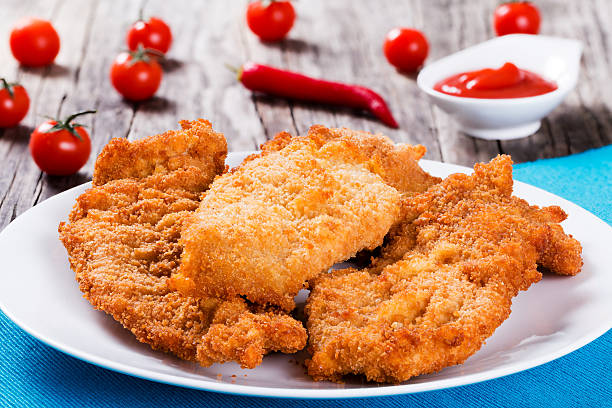 istock Bread Crumb Coated Fried Chicken breast on a white dish 540211740