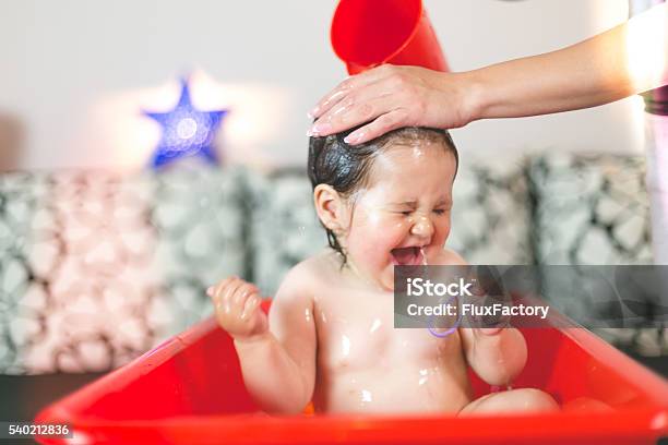 Mother Washing Babys Hair Pouring Water Stock Photo - Download Image Now - Baby Bathtub, Washing Hair, Baby - Human Age