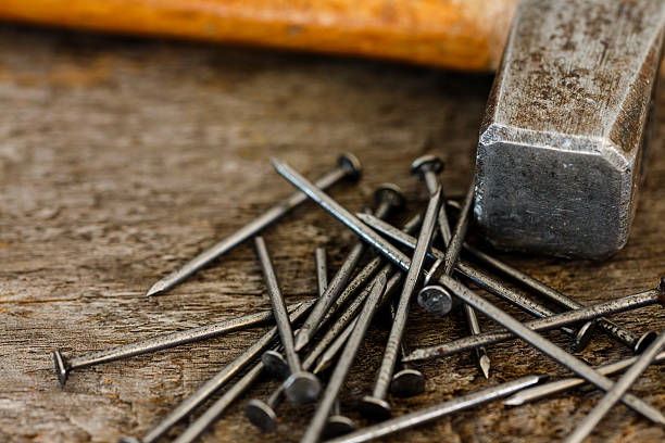 istock Hammer and Nails Work Tools On Wooden Background 540214770