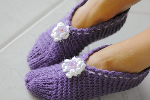 A pair of knitting bed slippers.   