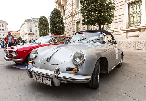 Vilnius, Lithuania - April 11, 2023: 1969 Porsche 911T, surrounded by other vintage cars in a private collection. Car after full restoration, painted in elegant grey colour.