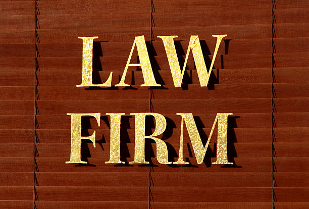 Window with brown shades and LAW FIRM in gold lettering stock photo