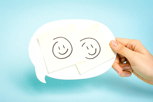 istock Two happy emoticons on speech bubble on blue background. 540219566