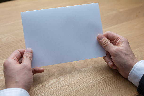 istock businessman holding white blank paper 540222600