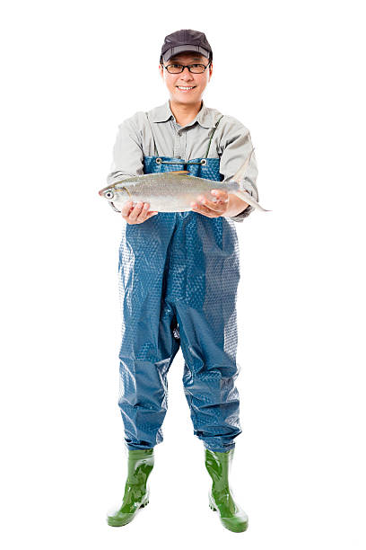 счастливый рыбак с большой рыбой изолированный на белом - manual worker full length isolated on white standing стоковые фото и изображения