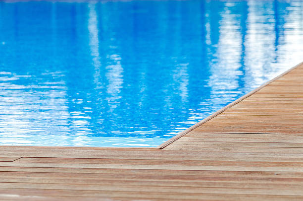 Swimming pool and wooden deck stock photo