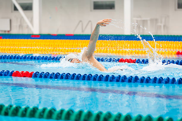 istock Man swimmer swimming crawl in blue water. 540226112