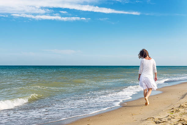 istock Girl standing at the beach 540226616
