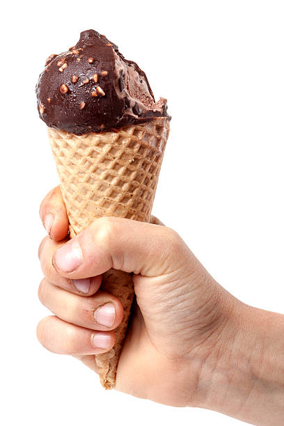 istock child' hand holding bitten off ice cream isolated on white 540226804