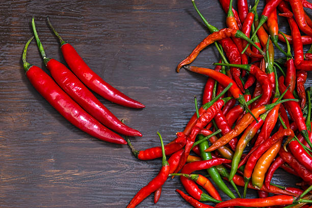 istock Chilli on wooden background, overhead view. low key tone. 540228788