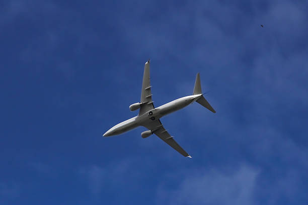 istock Airplane flying beneath a thin veil of cirrocumulus clouds 540228904