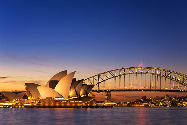 Beautiful Opera house view at twilight Sydney, Australia - September 5, 2013: Beautiful Opera house view at twilight time with vivid sky and illumination on the bridge. sydney stock pictures, royalty-free photos & images