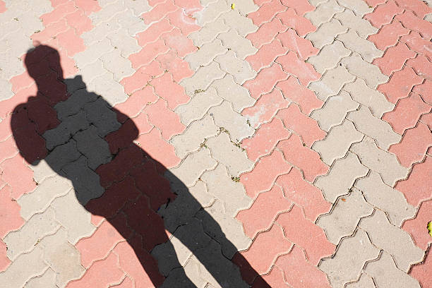 istock shadow man of road 540236726