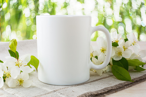 Mug mockup with apple blossom. Mug mockup. Coffee cup template. Coffee mug template. Mug template. Mug design template. Mug design. Mug printing design. White mug mockup. Cup mockup. Blank mug.