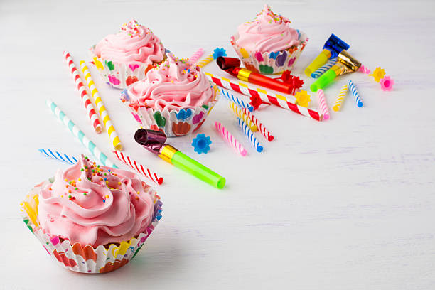 istock Pink cupcakes and candles birthday background 540237306