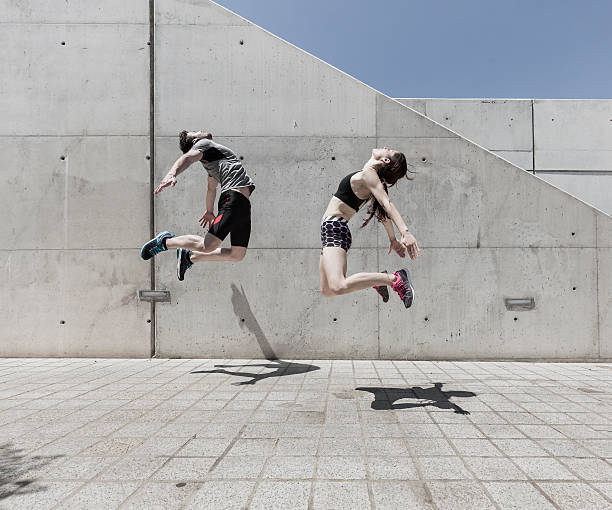 istock Man and woman jumping 540238472