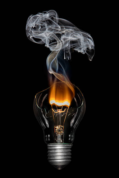 Broken Bulb with Smoke - Bournout Broken light  bulb with flame and smoke tungsten image stock pictures, royalty-free photos & images