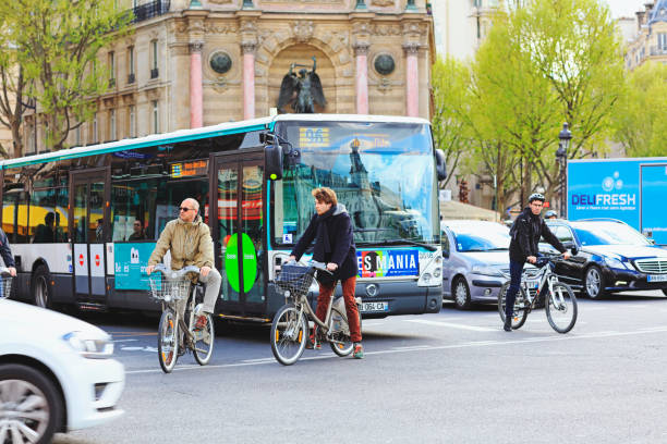 Paris, France - April 28, 2016:  Cyclist, cars and  big bus on the one way street Boulevard Saint-Michel