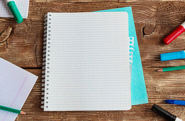 istock Notebook template mock up on a wooden table. Top view. 540240832