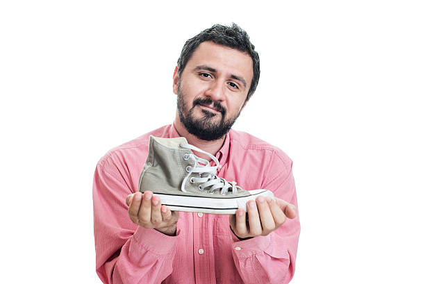 istock Businessman holding sneakers 540241506