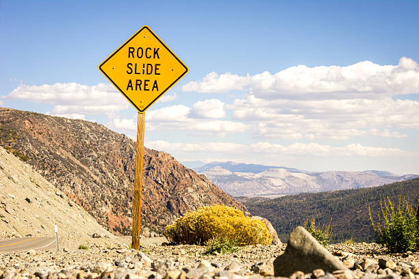 istock Road warning sign informing about rock slide area 540242758