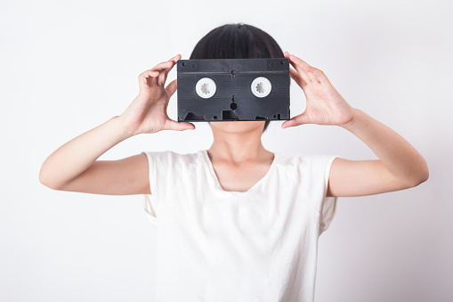 girl with video tape as mask