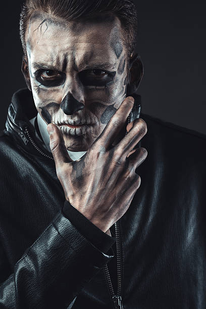 istock Portrait of pensive man with make-up  skull 540364814